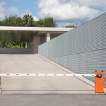 Entrée de parking avec barrière levante.